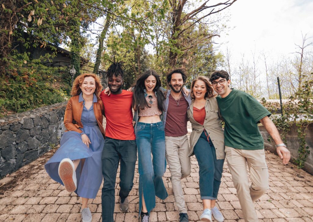 Happy Expat Community in Belgium A diverse group of happy friends walking together on a path, representing a thriving expat community in Belgium.